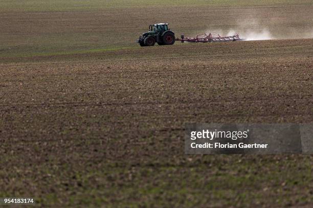 Tractor with a cultivator is pictured on a field on April 30, 2018 in Kunnerwitz, Germany.