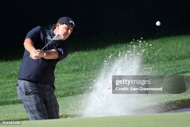 Phil Mickelson plays a shot from a bunker on the 15th hole during the first round of the 2018 Wells Fargo Championship at Quail Hollow Club on May 3,...