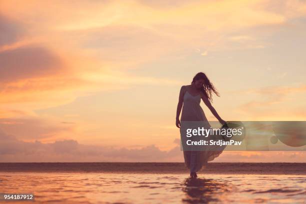 summer evening - woman long dress beach stock pictures, royalty-free photos & images