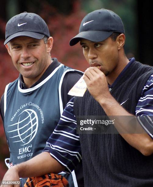 American golf star Tiger Woods eats a cereal bar on the 4th tee-off ground during the first day competition of the World Cup golf tournament at the...