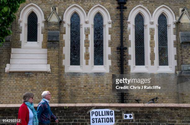 Voters walk into polling station in a church in Twickenham as voters go to the polls in the English local council elections on May 3, 2018 in London,...