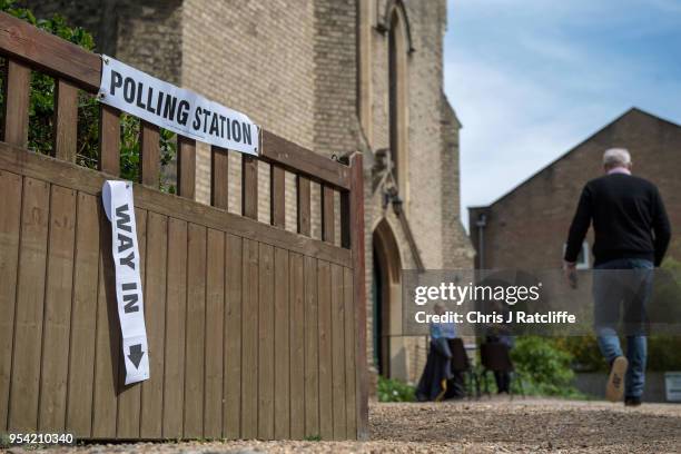 Man walks into a polling station in a church in Twickenham as voters go to the polls in the English local council elections on May 3, 2018 in London,...