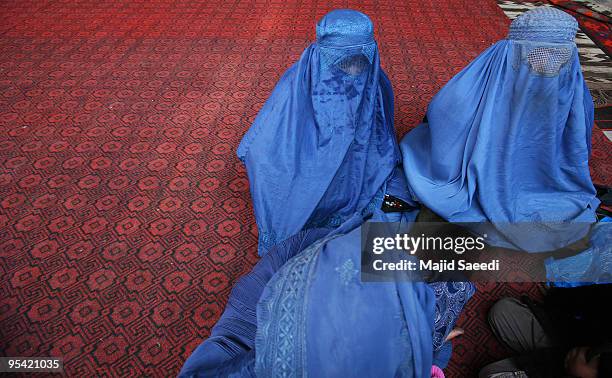 Afghan women sit during Ashura in Kabul, Afghanistan on December 27, 2009. Ashura is a 10 day period of mourning for Imam Hussein, the seven-century...