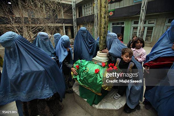 Afghan women pray during Ashura in Kabul, Afghanistan on December 27, 2009. Ashura is a 10 day period of mourning for Imam Hussein, the seven-century...