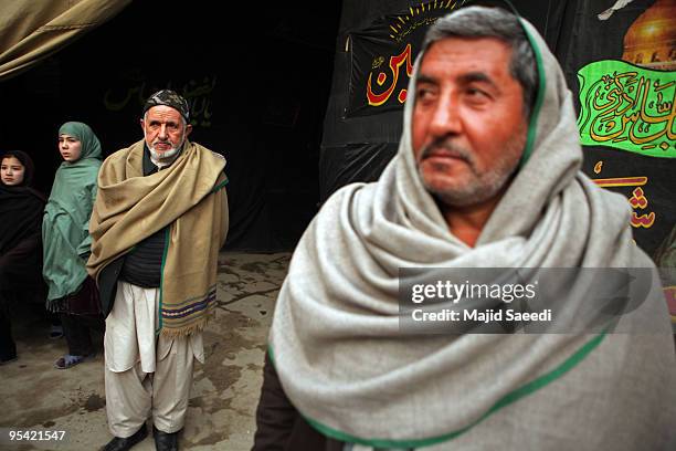 Afghan Shiite Muslim men commemorate Ashura at a Shiite mosque on December 27, 2009 in Kabul, Afghanistan. Ashura is a period of mourning in...