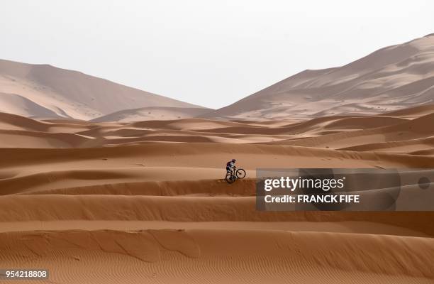Competitor rides his bike along a sand dune during Stage 5 of the 13th edition of Titan Desert 2018 mountain biking race around Merzouga in Morocco...