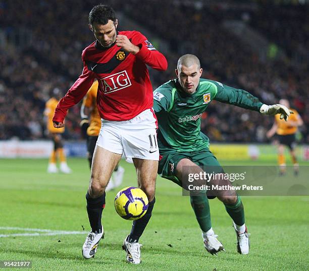 Ryan Giggs of Manchester United rounds Boaz Myhill of Hull City during the Barclays Premier League match between Hull City and Manchester United at...