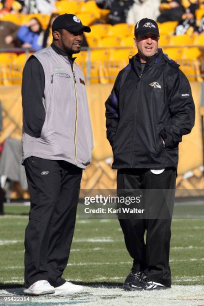 Head coach John Harbaugh of the Baltimore Ravens and head coach Mike Tomlin of the Pittsburgh Steelers meet at midfield before the game at Heinz...