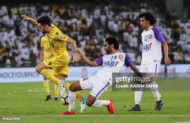 Al-Ain's Egyptian midfielder Hussein El Shahat vies for the ball against Al-Wasl's Australian midfielder Anthony Caceres , during the United Arab...