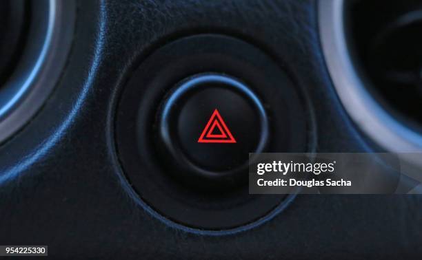 close-up of a button for controlling the vehicles exterior hazard lights - car blinker stock pictures, royalty-free photos & images