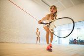 Young beautiful women playing squash