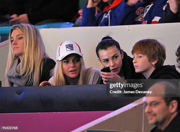 Lindsay Lohan, Ali Lohan and Dakota Lohan attend the New York Islanders vs New York Rangers game at Madison Square Garden on December 26, 2009 in New...