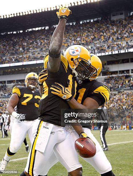 Santonio Holmes of the Pittsburgh Steelers celebrates a second quarter touchdown with Mike Wallace while playing the Baltimore Ravens on December 27,...