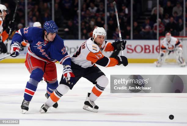 Rob Schremp of the New York Islanders skates against Brian Boyle of the New York Rangers on December 26, 2009 at Madison Square Garden in New York...