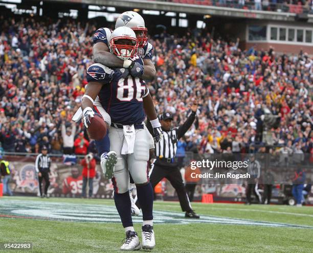 Chris Baker of the New England Patriots celebrates with team mate Benjamin Watson after Baker caught a touchdown in the first half against the...
