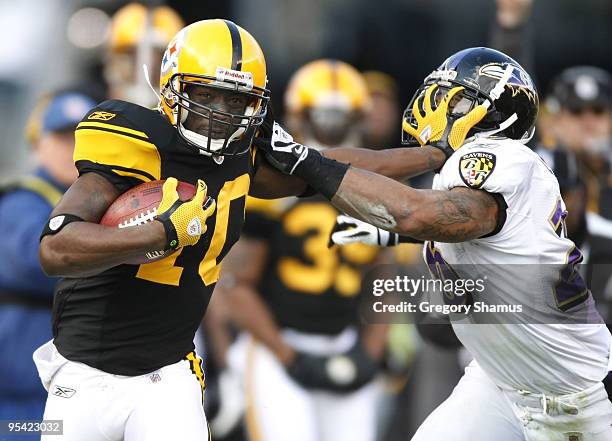 Santonio Holmes of the Pittsburgh Steelers tries to get around the tackle of Dawan Landry of the Baltimore Ravens on December 27, 2009 at Heinz Field...