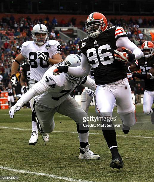 David Bowens of the Cleveland Browns is chased by Cornell Green of the Oakland Raiders at Cleveland Browns Stadium on December 27, 2009 in Cleveland,...