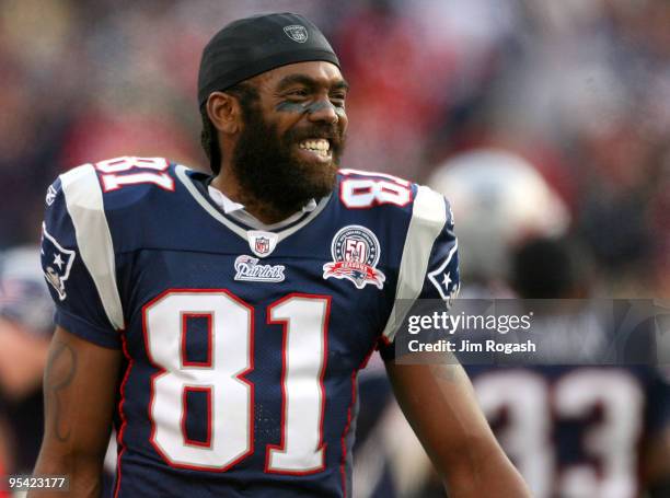 Randy Moss of the New England Patriots reacts on the sideline after he caught his third touchdown pass of the day against the Jacksonville Jaguars in...