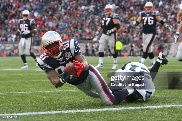 Randy Moss of the New England Patriots catches his third touchdown pass of the day against the Jacksonville Jaguars in the fourth quarter at Gillette...