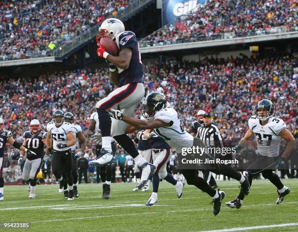 Randy Moss of the New England Patriots catches his third touchdown pass of the day against the Jacksonville Jaguars in the fourth quarter at Gillette...
