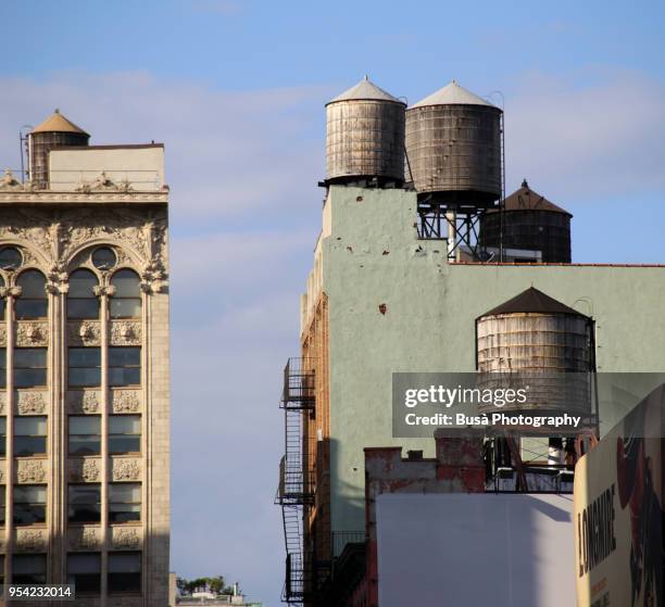 rusty water towers on rooftops in manhattan, new york city, usa - water tower storage tank stock pictures, royalty-free photos & images