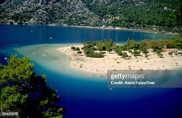 fethiye oludeniz beach surrounded by blue water - caria stock pictures, royalty-free photos & images