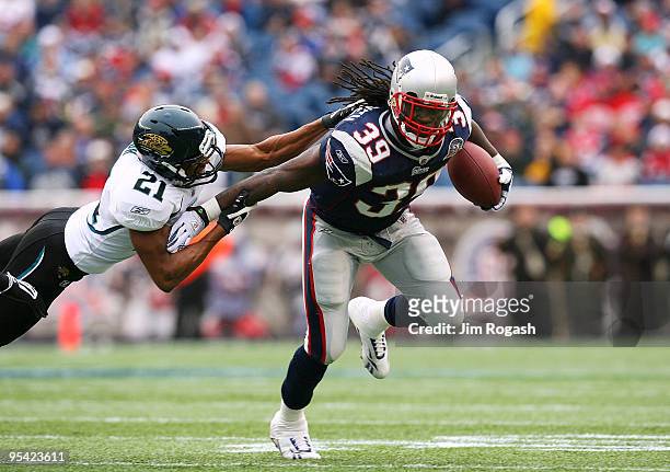 Laurence Maroney of the New England Patriots gains yards against Derek Cox of the Jacksonville Jaguars in the first quarter at Gillette Stadium on...