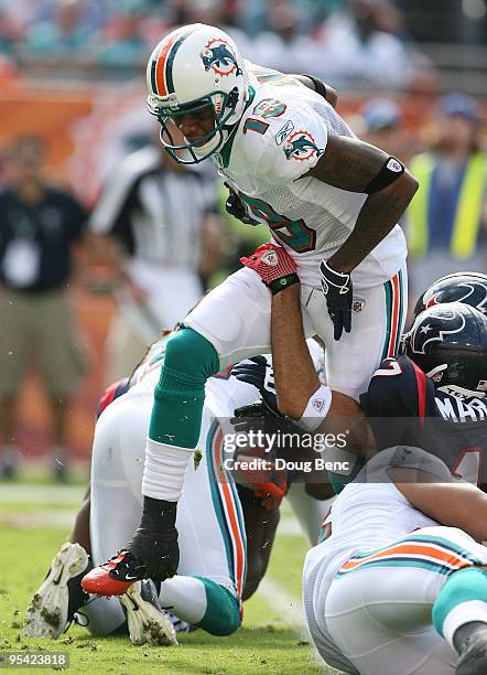 Wide receiver Ted Ginn Jr. #19 of the Miami Dolphins tries to find room to run against the Houston Texans at Land Shark Stadium on December 27, 2009...