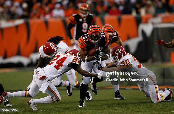 Cedric Benson of the Cincinnati Bengals is tackled by Brandon Flowers and Mike Brown of the Kansas City Chiefs in their NFL game at Paul Brown...