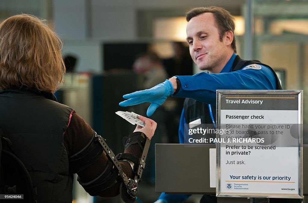 An airline passenger has her boarding pa