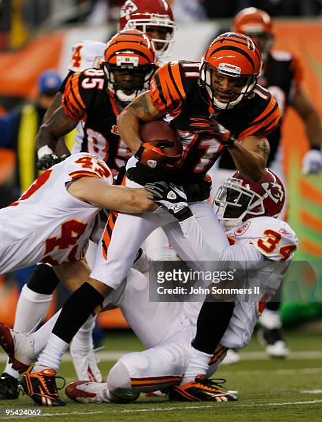Laveranues Coles of the Cincinnati Bengals is tackled by Jon McGraw and Travis Daniels of the Kansas City Chiefs in their NFL game at Paul Brown...