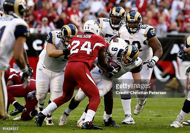 Quarterback Keith Null of the St. Louis Rams is sacked by Adrian Wilson of the Arizona Cardinals during the second quarter of the NFL game at the...