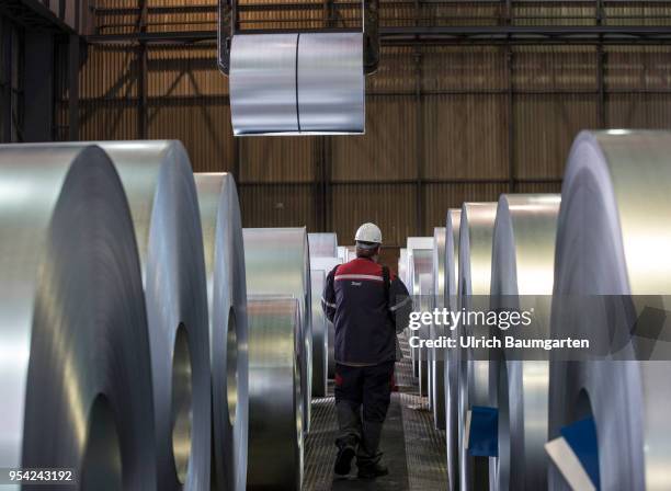 Steel production at ThyssenKrupp in Duisburg. The picture shows a worker during transport of a steel roll in a storage hall for cold-rolled sheet.