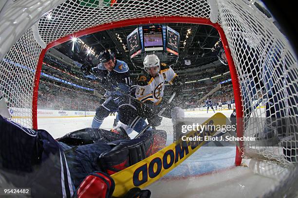 Goaltender Scott Clemmensen of the Florida Panthers defends the net with teammate Gregory Campbell against Patrice Bergeron of the Boston Bruins at...