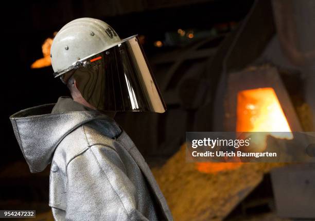 Steel production at ThyssenKrupp in Duisburg. The picture shows a worker in protective clothing in front of a blast furnace just before the blast...