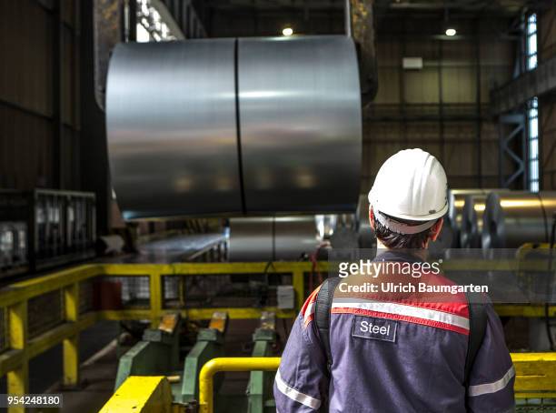 Steel production at ThyssenKrupp in Duisburg. The picture shows a worker during transport of a steel roll in a storage hall for cold-rolled sheet.