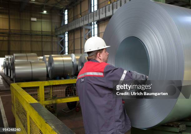 Steel production at ThyssenKrupp in Duisburg. The picture shows a worker at a finished produced steel roll in a storage hall for cold-rolled sheet.