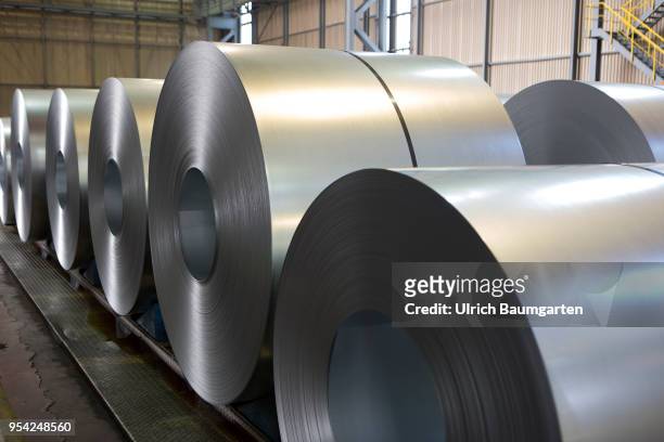 Steel production at ThyssenKrupp in Duisburg. The picture shows a worker between steel rolls in a storage hall for cold-rolled sheet.