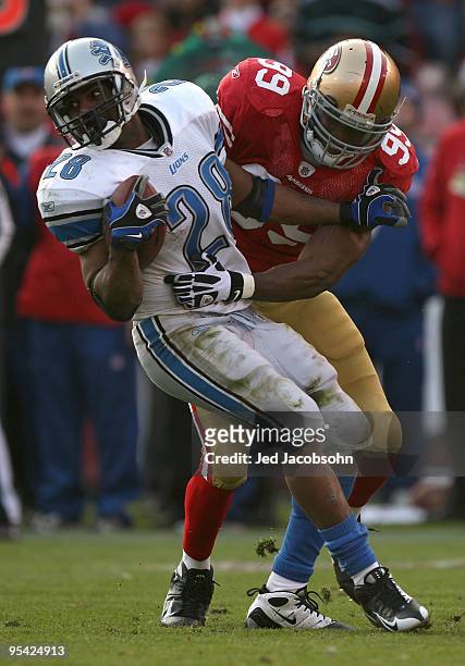 Manny Lawson of the San Francisco 49ers tackles Maurice Morris of the Detroit Lions during an NFL game at Candlestick Park on December 27, 2009 in...