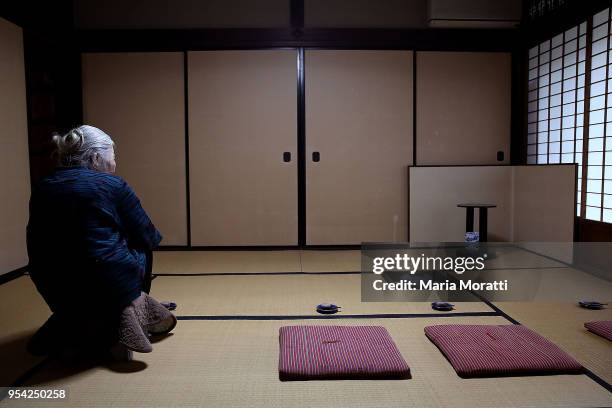 An old woman waits for the traditional tea ceremony in her house on April 19, 2018 in Kyoto, Japan. Kyoto, literally "Capital City", is a city...