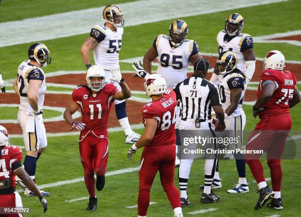 Wide receiver Larry Fitzgerald of the Arizona Cardinals celebrates with teammate Anthony Becht after scoring on a 10 yard touchdown reception against...