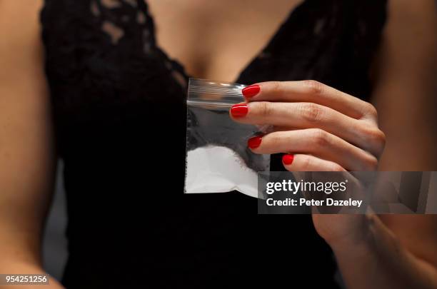 woman offering plastic bag of drugs - kokain stock-fotos und bilder