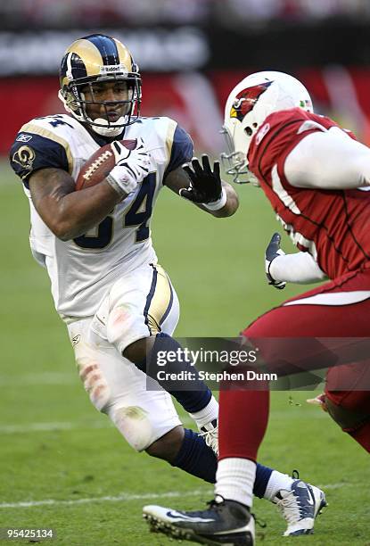 Running back Kenneth Darby of the St. Louis Rams carries the ball against linebacker Karlos Dansby of the Arizona Cardinals on December 27, 2009 at...