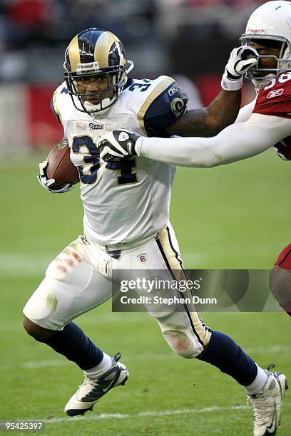 Running back Kenneth Darby of the St. Louis Rams carries the ball against linebacker Karlos Dansby of the Arizona Cardinals on December 27, 2009 at...