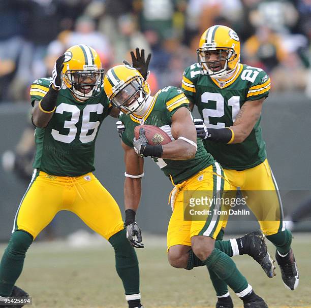 Jarrett Bush of the Green Bay Packers celebrates a sack with teammates Nick Collins and Charles Woodson during an NFL game against the Seattle...