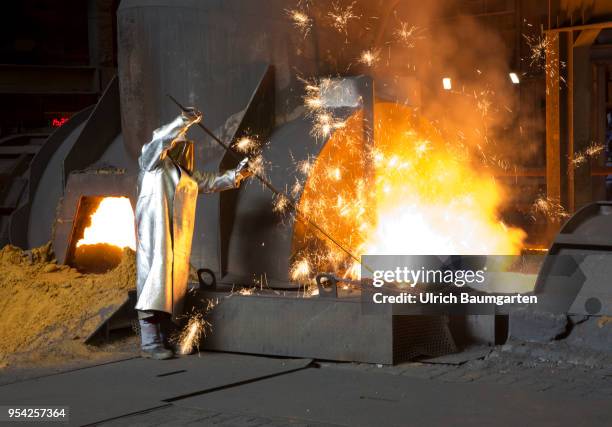 Steel production at ThyssenKrupp in Duisburg. The picture shows a worker in protective clothing in front of a blast furnace during blast furnace...