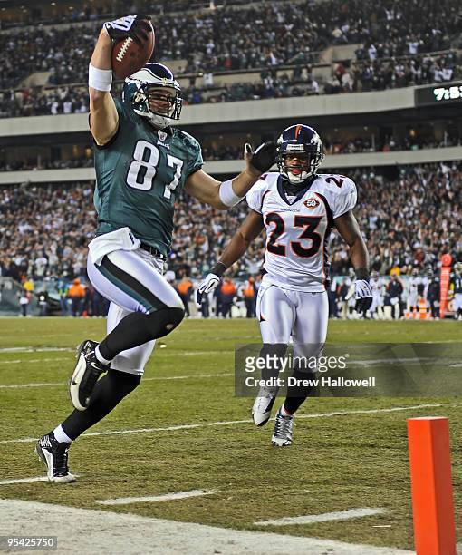 Tight end Brent Celek of the Philadelphia Eagles runs into the end-zone for a touchdown in front of safety Renaldo Hill of the Denver Broncos on...