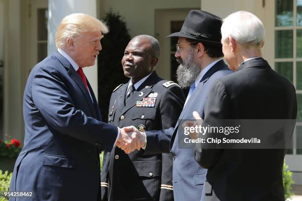 President Donald Trump greets US Army Chaplain Corps Lieutenant Colonel Dawud Abdul-Aziz Agbere, Rabbi Levi Shemtov of the Rabbinical Council of...