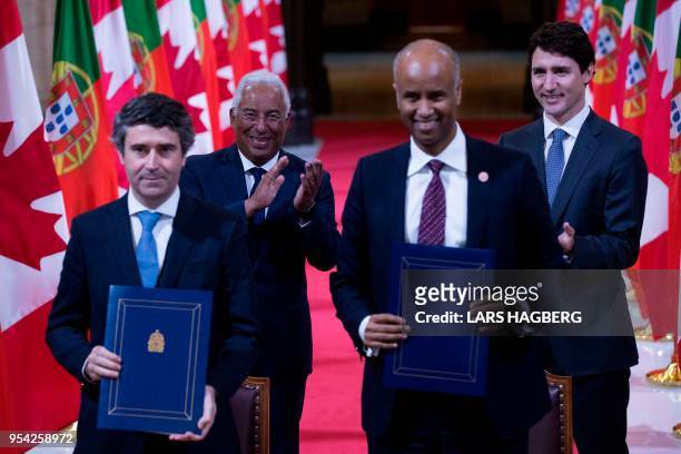 Portuguese Prime Minister António Costa and Canadian Prime Minister Justin Trudeau clap hands in the Hall of Honour after Canadian and Portuguese...