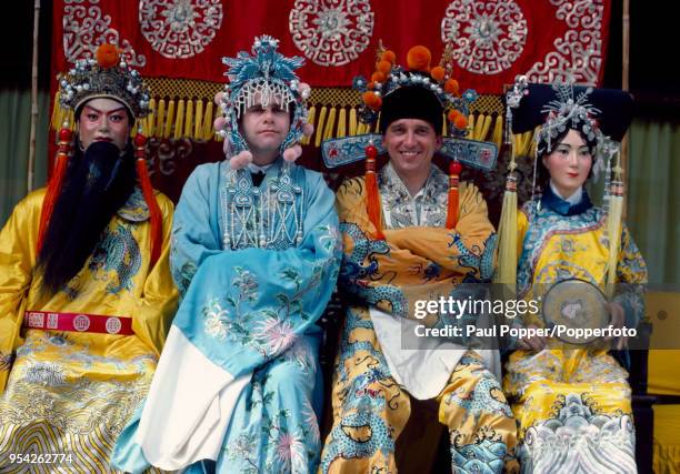 Watford chairman Elton John and manager Graham Taylor in traditional Chinese costumes at the Summer Palace in Beijing during their exhibition tour of...